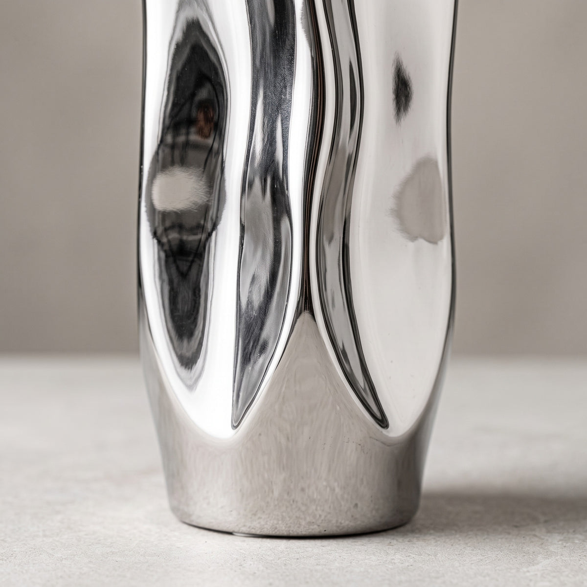 Close-up of the folded silver walls of the vase