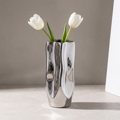 Silver crumpled vase holding white tulips (flowers not included)